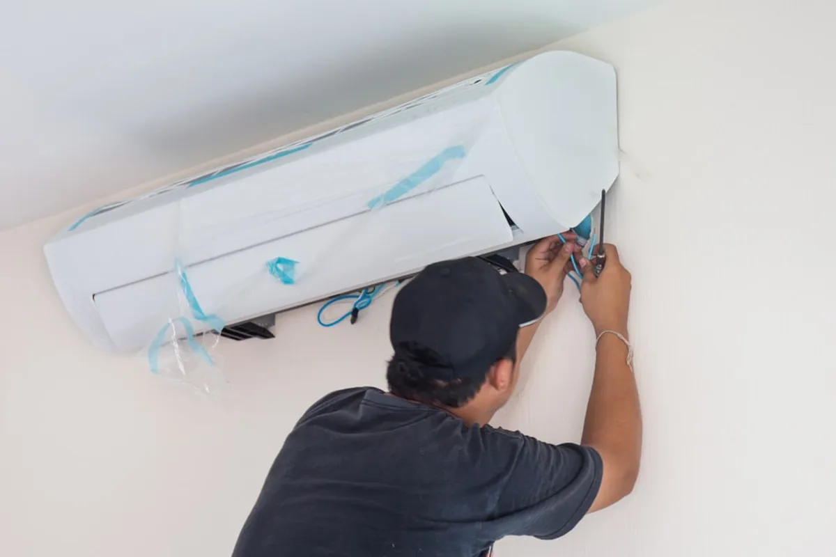 HVAC service in Glendale — Technician servicing a home AC system in Glendale