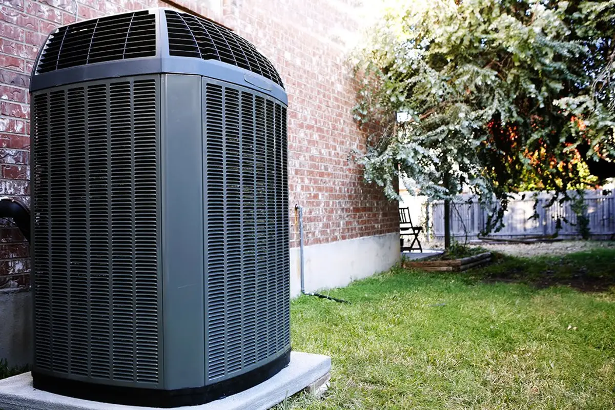 Newly installed air conditioning condenser unit beside a home