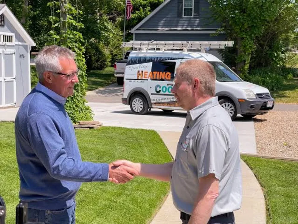 Friendly HVAC technician explaining the repair to a homeowner